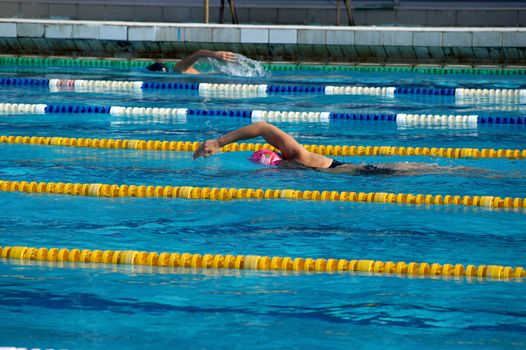 Girl swimmer in the outdoor swimming pool