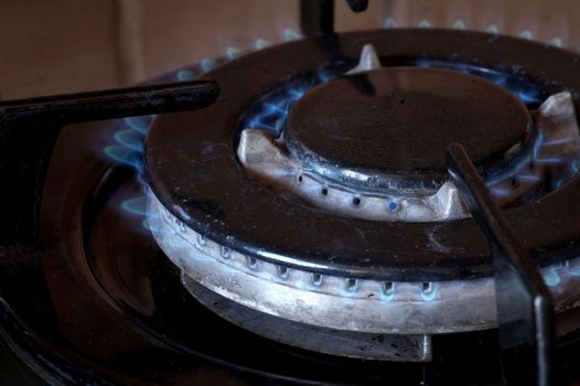 burning gas on a double-row gas ring on the stove