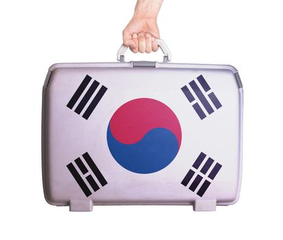 Used plastic suitcase with stains and scratches, printed with flag, South Korea