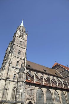 Saint Lawrence cathedral (St. Lorenz) over clear blue sky, medieval gothic church in Nuremberg, Germany, low angle side view