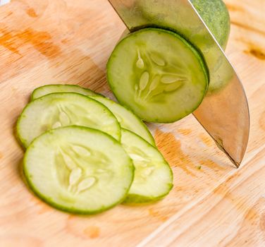 Slicing some cucumber ready to put in the salad