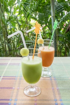 Fresh melon smoothie in a glass on the table