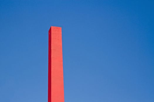 Pink rectangular chimney with blue sky