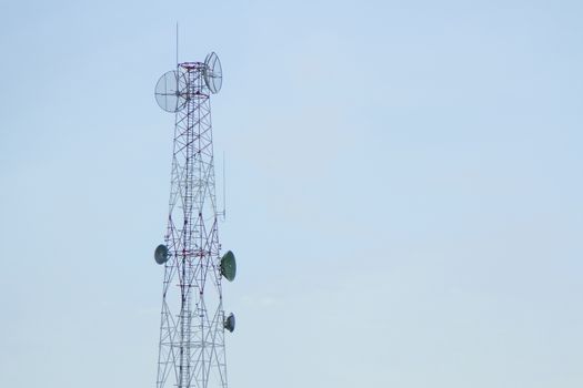 Mobile phone communication tower transmission with blue sky background and antenna