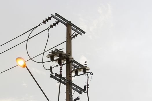 Power poles with lights in the evening.