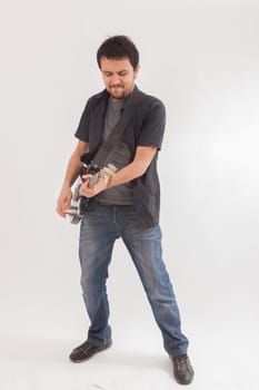 young man jumping with electric guitar on white background