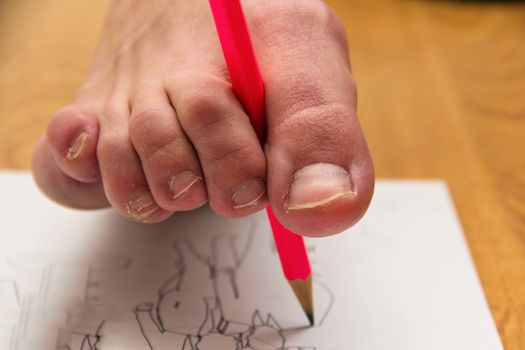 A woman paints a picture with a colorless pencil with a finger of her foot.