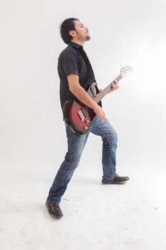 young man jumping with electric guitar on white background