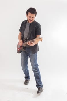 young man jumping with electric guitar on white background