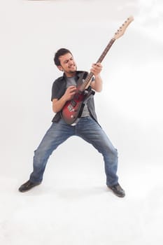 young man jumping with electric guitar on white background