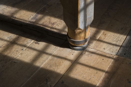 Interior of a historic wooden mill with a detail of an old wooden crusher in the area with beautiful light
