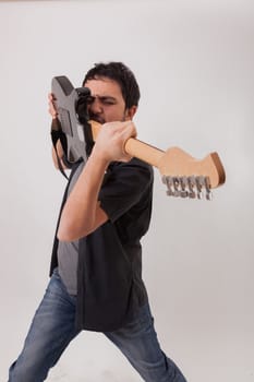 young man jumping with electric guitar on white background