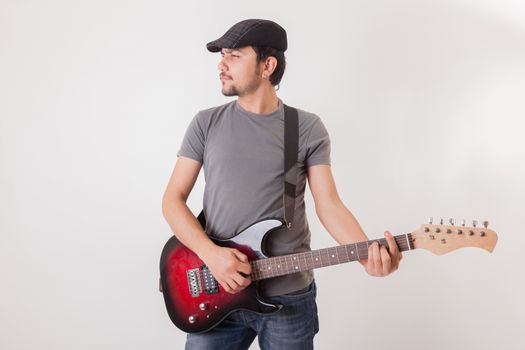 young man jumping with electric guitar on white background