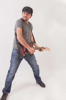 young man jumping with electric guitar on white background