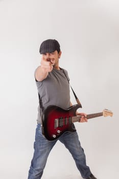 young man jumping with electric guitar on white background