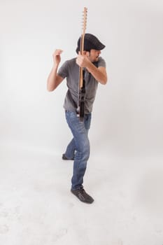 young man jumping with electric guitar on white background