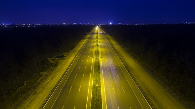 Aerial, vertical - Traffic at night. Roundabout over highway