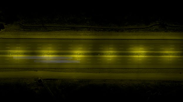 Aerial, vertical - Traffic at night. Roundabout over highway
