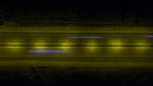 Aerial, vertical - Traffic at night. Roundabout over highway