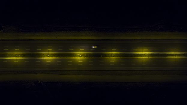 Aerial, vertical - Traffic at night. Roundabout over highway