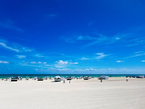 Beach in South Beach, Florida, a city near Miami, with white sand and blue sky, on a suuny day.