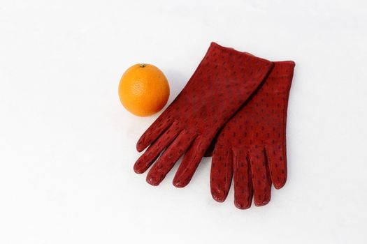 women's hands in gloves. keep snow and orange. white background, winter.