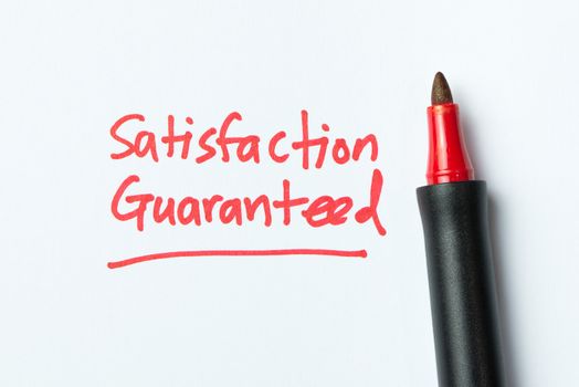 Handwriting of satisfaction guarantee with red color pen