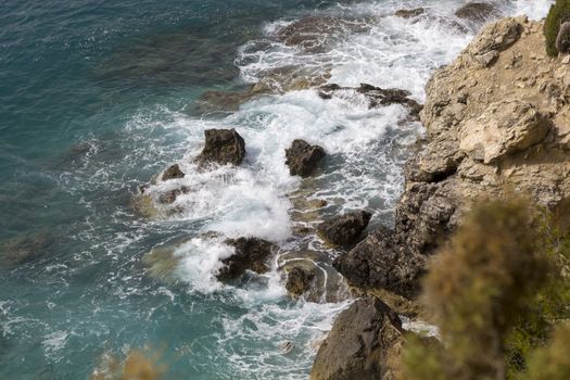 Overhead View Ocean and Rocky Cliff with wave