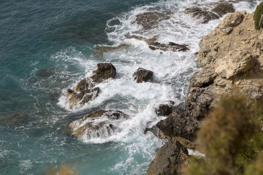 Overhead View Ocean and Rocky Cliff with wave