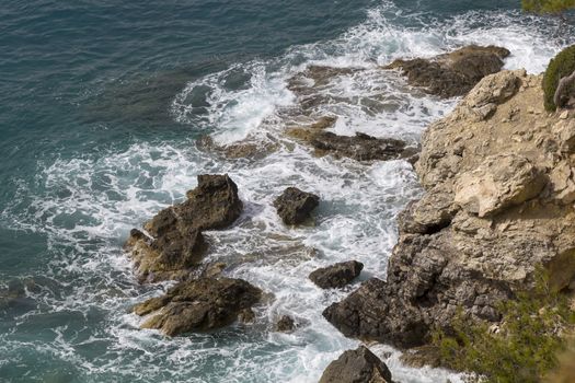 Overhead View Ocean and Rocky Cliff with wave