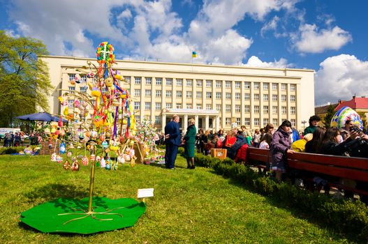 Uzhgorod, Ukraine - April 07, 2017: Celebrating Orthodox Easter in Uzhgorod on the Narodna square. Celebration in front of Transcarpathian Regional Administration building on a warm springtime day