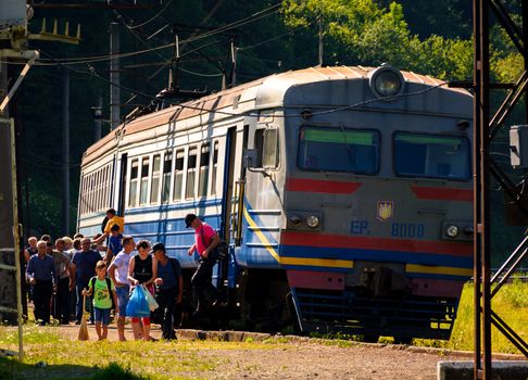 Huklyvyi, Ukraine - 20 Jul, 2017: ancient electric train arrival. people quickly take off