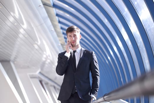 Businessman talking on the phone in modern building