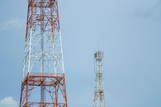 Two signal tower with blue sky.