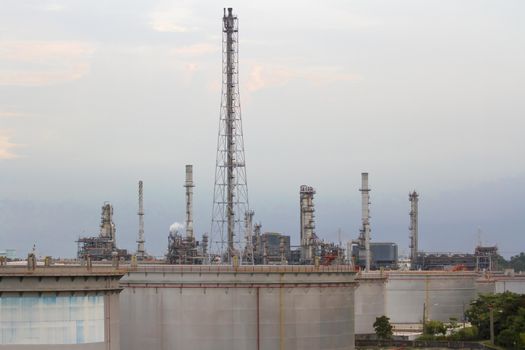 Oil refinery with evening sky.