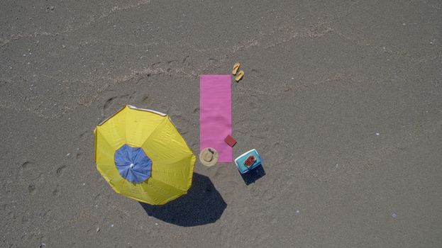 AERIAL: Pretty young woman sunbathing on beach Antalya