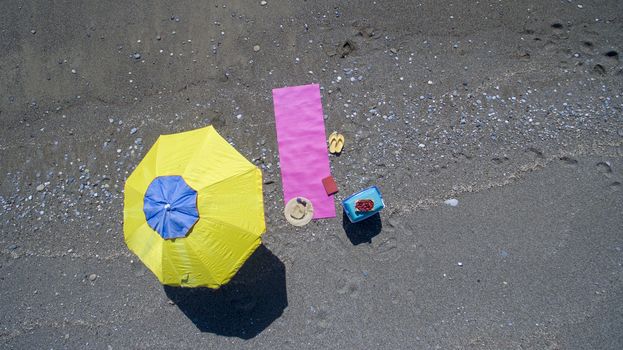 AERIAL: Pretty young woman sunbathing on beach Antalya