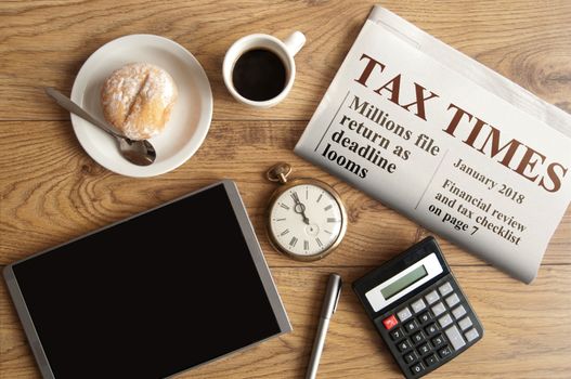 Tax times mock up newspaper with clock, calculator and tablet