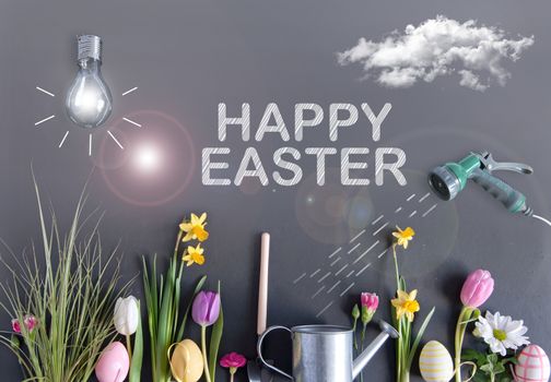 Easter flower garden with light bulb as sun, clouds, and hose watering flowers laid flat on a chalkboard 