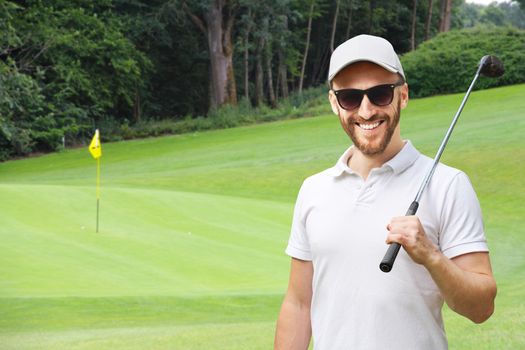 Portrait of male golfer with golf club at course