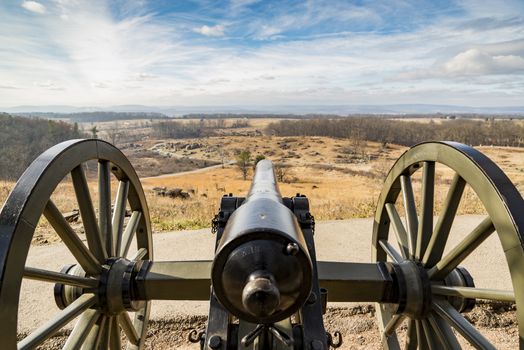 Civil war canon behind a stone wall on the Gettysburg battlefield in Autumn near sunset