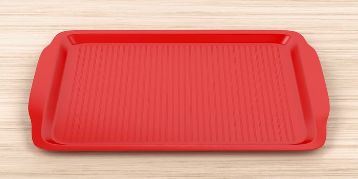Empty red plastic tray on wood table