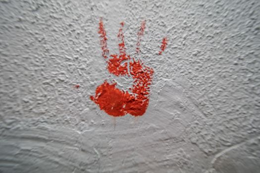 bloody palm print on concrete wall crime scene