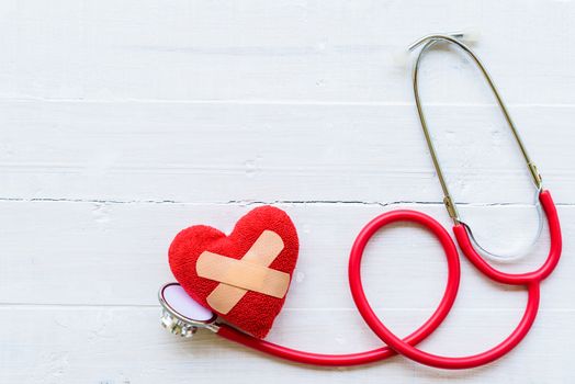 World health day, Healthcare and medical concept. Stethoscope, red heart, notepad or notebook, thermometer and yellow Pill on Pastel white and blue wooden table background texture.