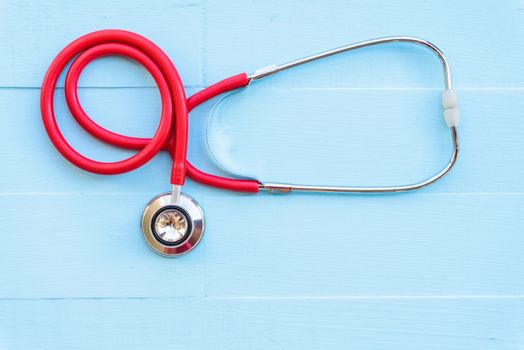 World health day, Healthcare and medical concept. Red heart with Stethoscope, notepad or notebook, thermometer and yellow Pill on Pastel white and blue wooden table background texture.