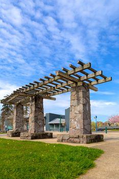 Wood and Stone Pergola structure in Happy Valley Green Village city park by the library in spring season