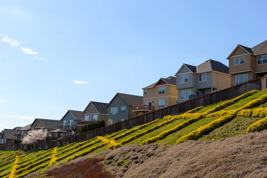 Hillside homes in North American suburban neighborhood with backyard wood deck view