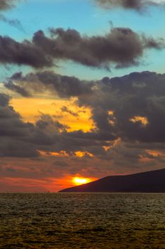 Nature in twilight period which including of sunrise over the sea and the nice beach. Summer beach with blue water and purple sky at the sunset.