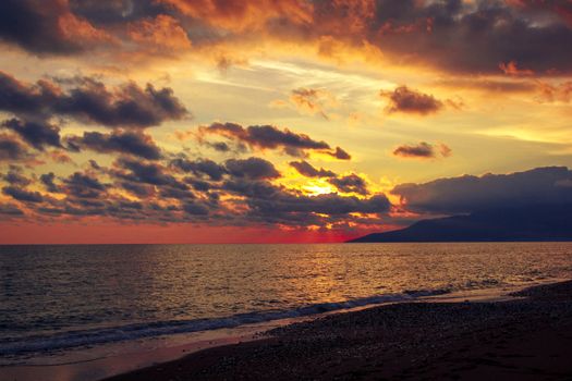 Nature in twilight period which including of sunrise over the sea and the nice beach. Summer beach with blue water and purple sky at the sunset.