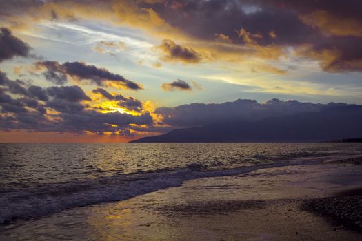 Nature in twilight period which including of sunrise over the sea and the nice beach. Summer beach with blue water and purple sky at the sunset.